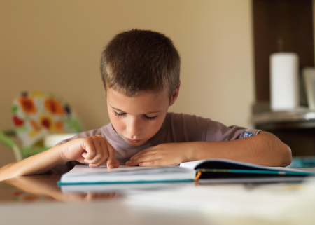 Photo of young boy reading