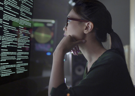 Photo of student examining data on a screen