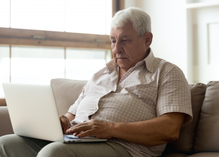 Photo of older man on a computer