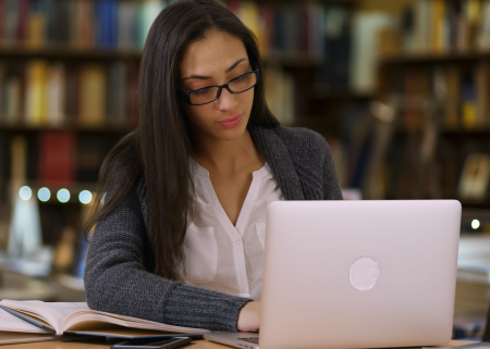 Photo of woman scholar working on her computer