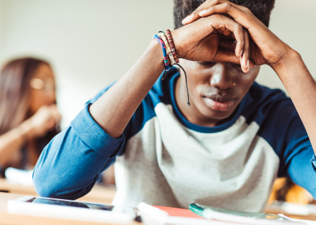 Student in concentration at his desk.