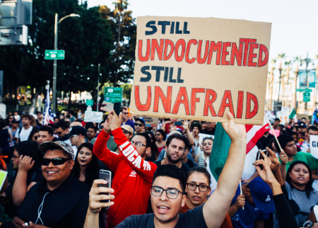 Photo of protesters with poster saying "Still Undocumented, Still Unafraid"