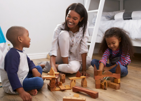 Mother playing blocks with her kids