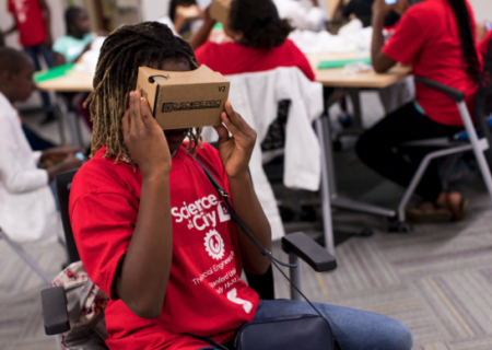 A Science in the City student using a cardboard virtual reality viewer