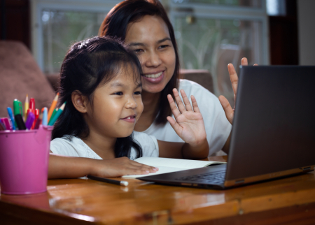 Mother and child doing school on a laptop