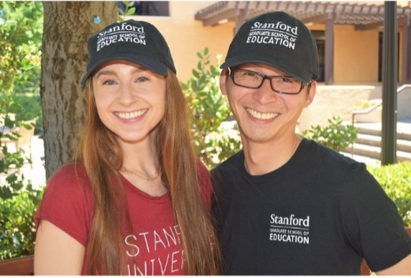 Two persons wearing Stanford GSE swag.