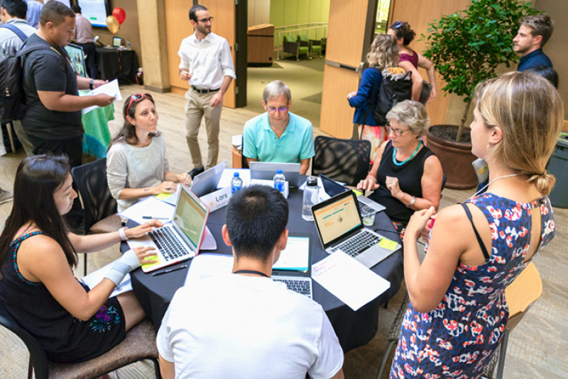 Photo of a group of alumni around a table.