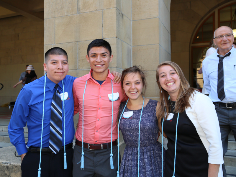 Photo of four students during GSE honor's cord ceremony