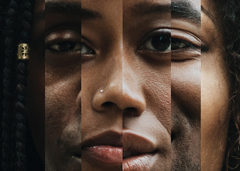 Photo of a Black woman's face in a prism-like mirror