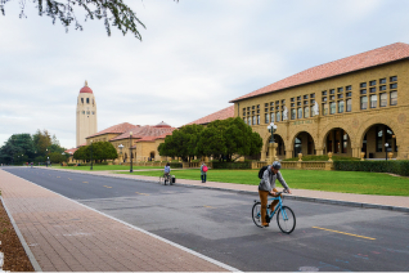 Student riding bicycle on Stanford campus