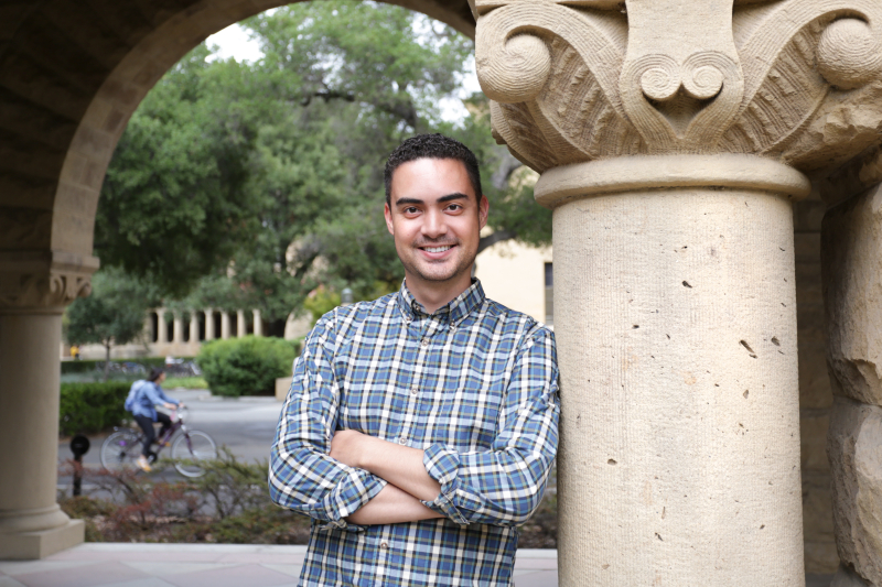 Photo of Tanner Vea leaning on a column 