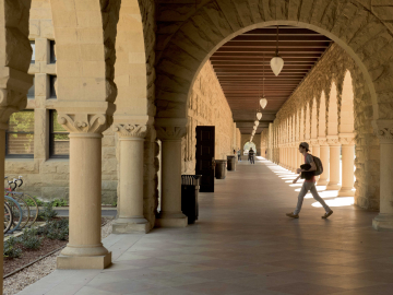 Student crossing a path on a university campus