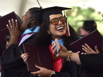 GSE students cheer as fellow graduates receive their diplomas on Sunday, June 16. (Photo: Charles Russo)