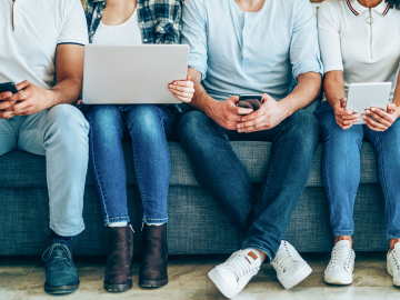 Photo of young people with a variety of online news devices