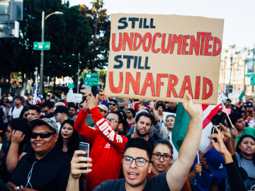 Photo of protesters with poster saying "Still Undocumented, Still Unafraid"