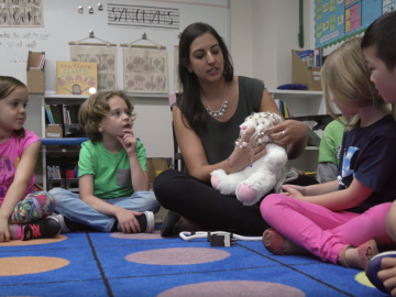Picture of Elizabeth Toomarian teaching children about neuroscience with a stuffed bunny rabbit.