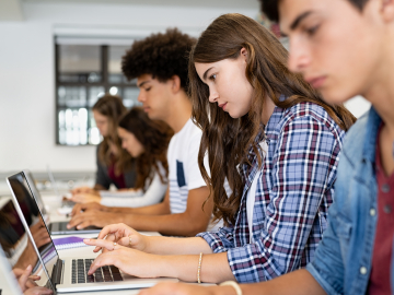 Students typing on laptops