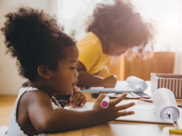 Photo of two children doing schoolwork at home