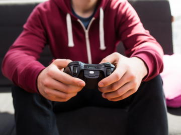 Man playing video games. Photo by Adobe Stock