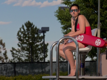 A lifeguard at a pool. A new study suggests summer youth employment may lead to improvements in school attendance and other educational outcomes. (Photo by www.learningdslrvideo.com)