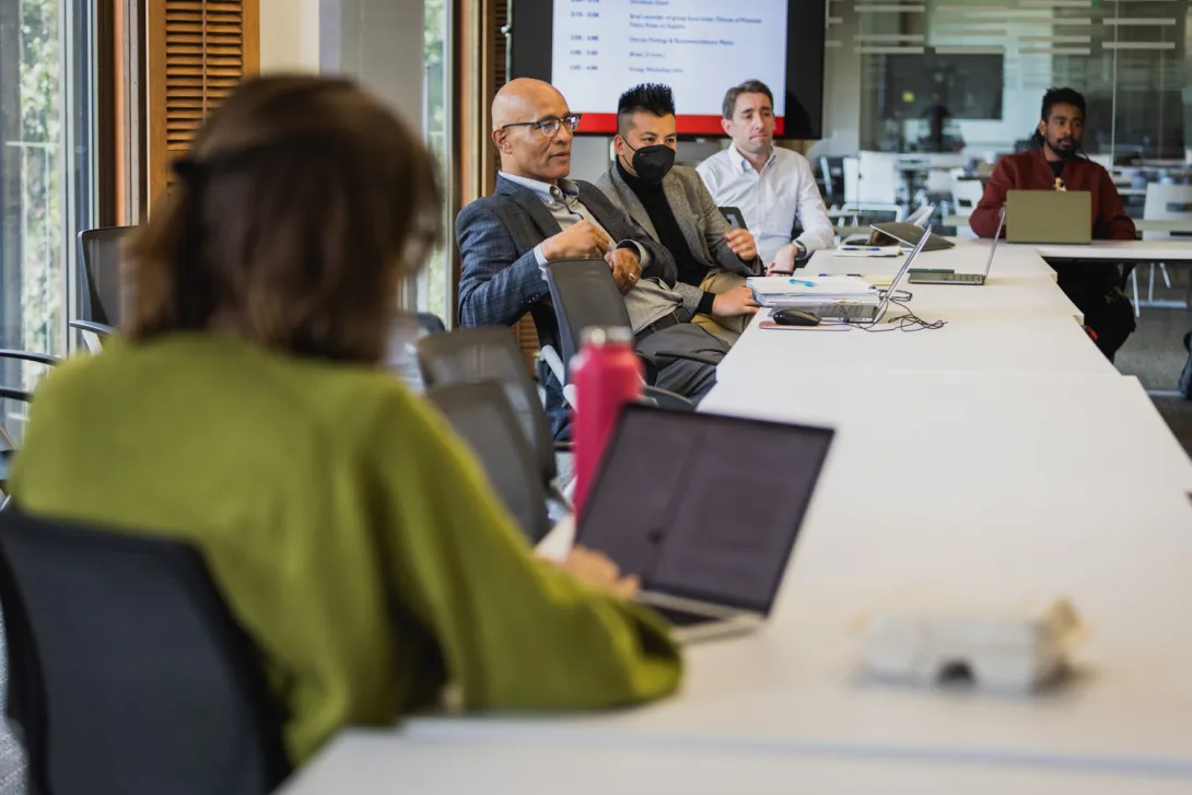 Students and faculty gather in a conference room during a lab session. (Photo: Kurt Hickman)