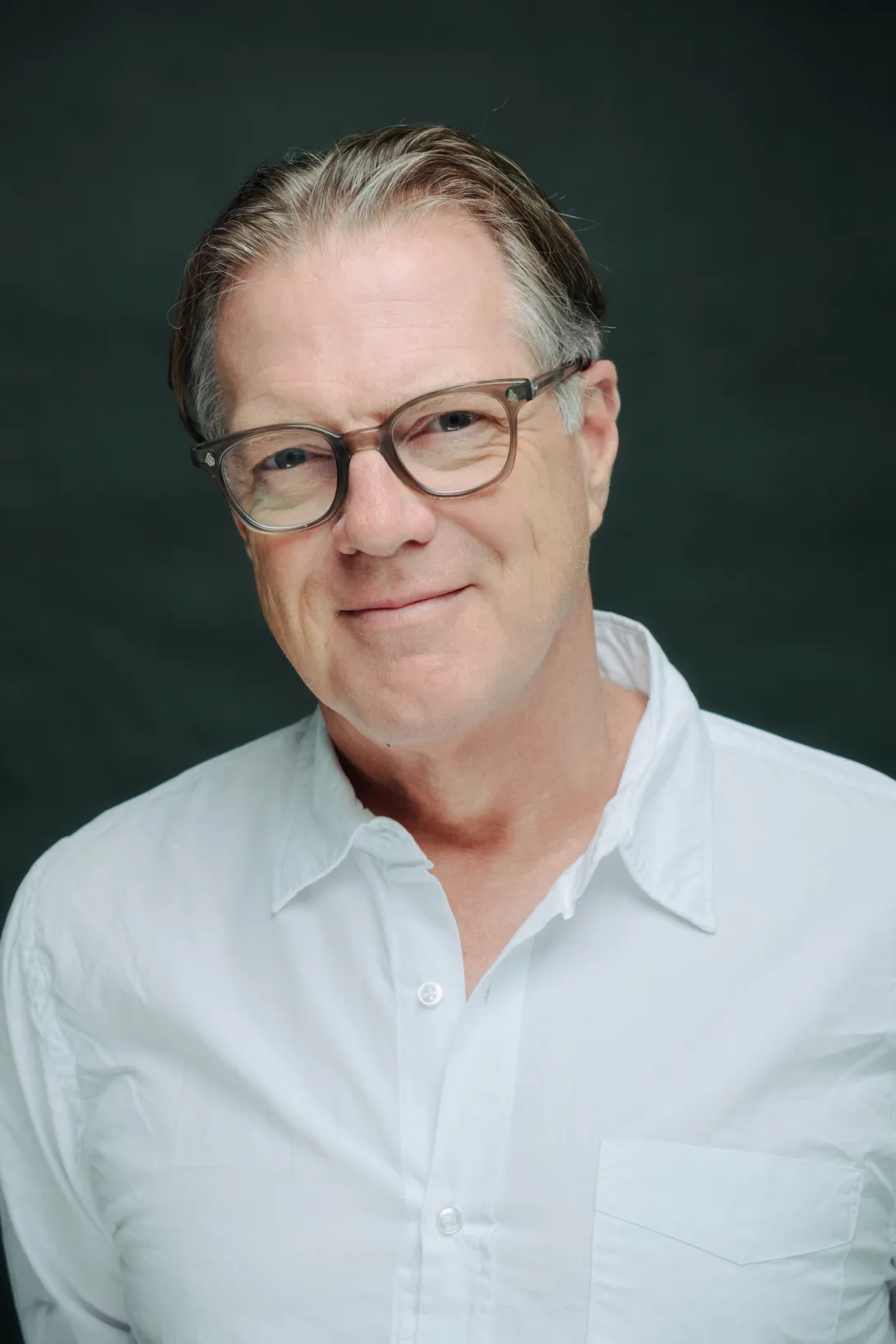 A studio photo of Mitchell Stevens against a dark background