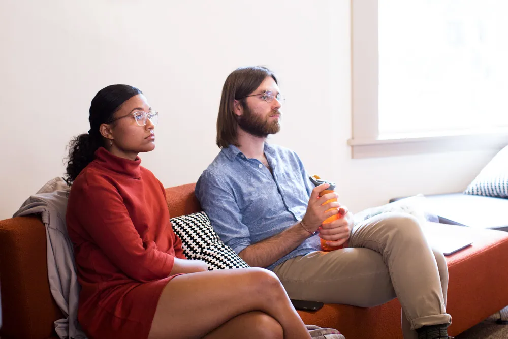 Two students sitting down looking ahead